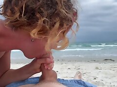 Deep oral pleasure on the beach, female in bathing suit deep-throating cock, jizz gullet outdoors